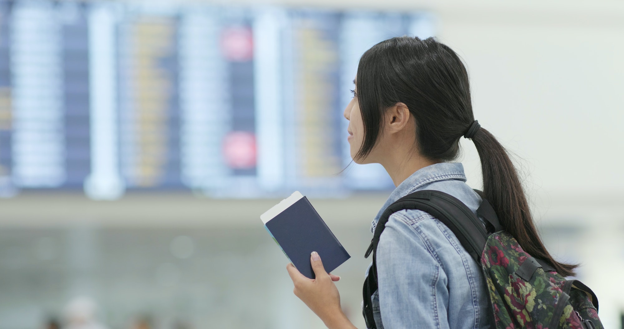 Woman holding passport in the airport