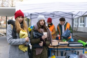 Ukrainian immigrants crossing border and getting donations from volunteers, Ukrainian war concept